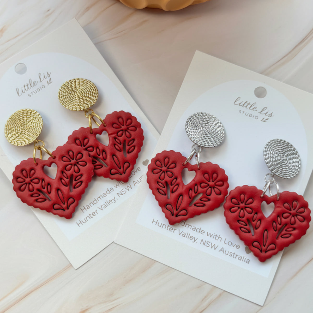 Amore statement Papel picado heart earring in a deep red colour, handmade from polymer clay by Little Lis Studio on siler or gold textured stud