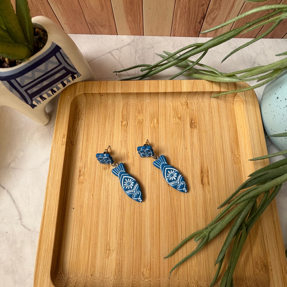 Handmade Kyma Fish polymer clay dangle earrings with Mediterranean-inspired detailing in Cobalt Blue / White