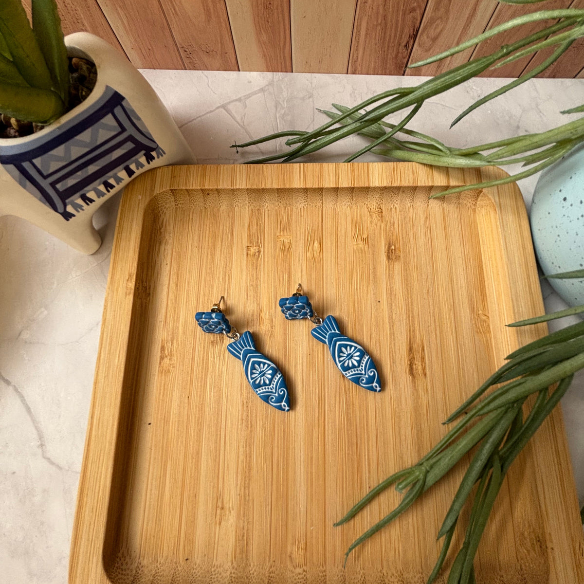 Handmade Kyma Fish polymer clay dangle earrings with Mediterranean-inspired detailing in Cobalt Blue / White
