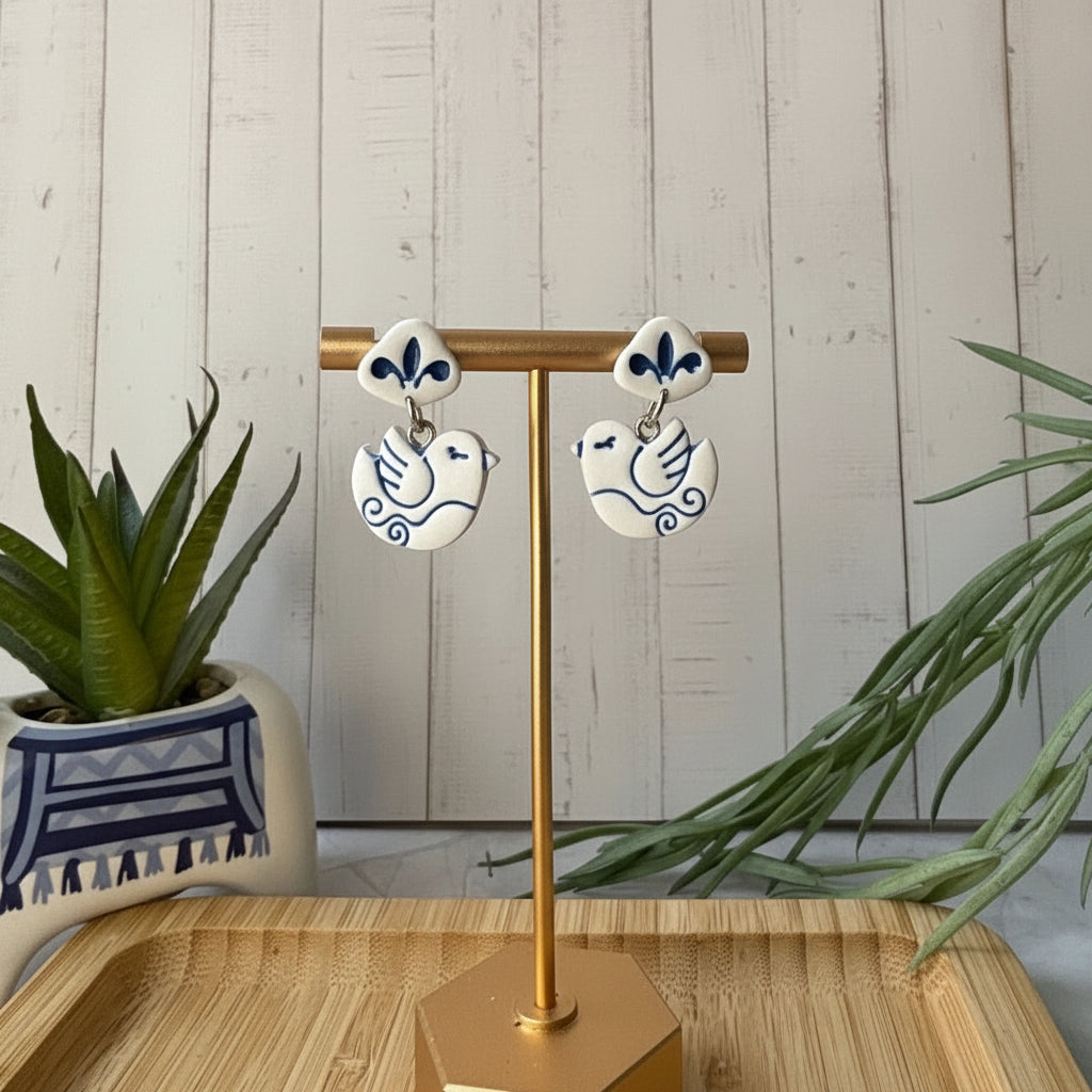 Handmade Nisi Bird Mediterranean polymer clay dangle earrings in white and cobalt blue by Little Lis Studio.