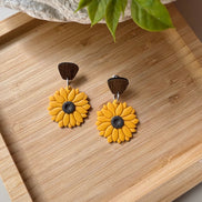 Yellow sunflower dangle earrings with brown wooden top pieces and dark brown centers, by little lis studio
