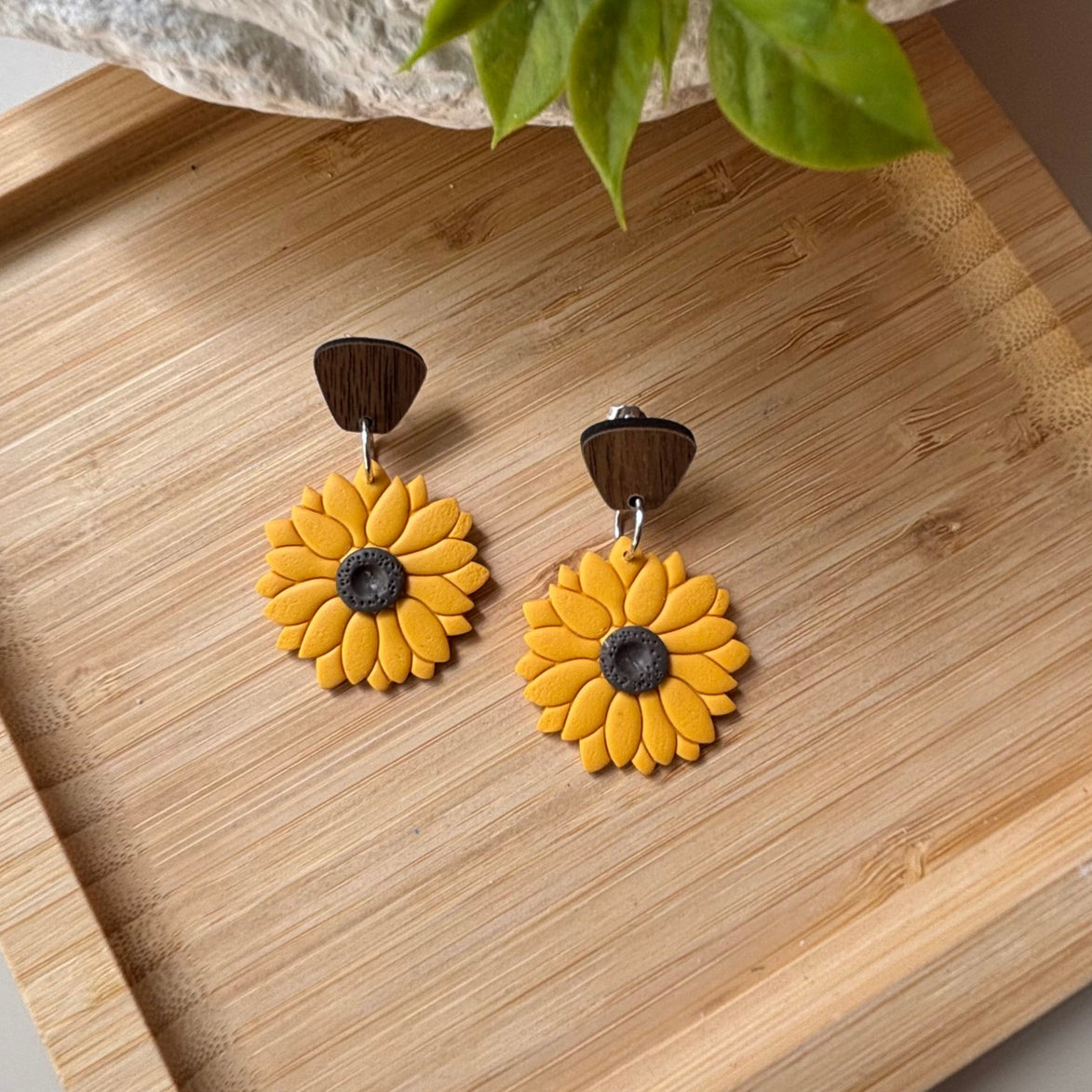 Yellow sunflower dangle earrings with brown wooden top pieces and dark brown centers, by little lis studio