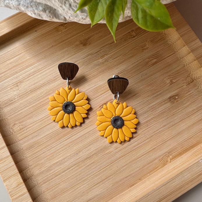 Yellow sunflower dangle earrings with brown wooden top pieces and dark brown centers, by little lis studio