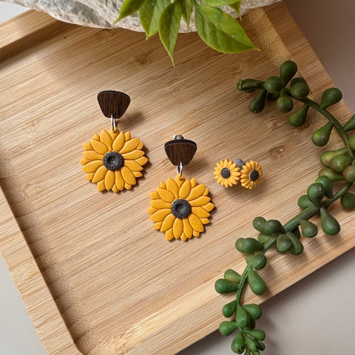 Yellow sunflower dangle earrings with brown wooden stud top and dark brown centers, by little lis studio, Shown with matching stud