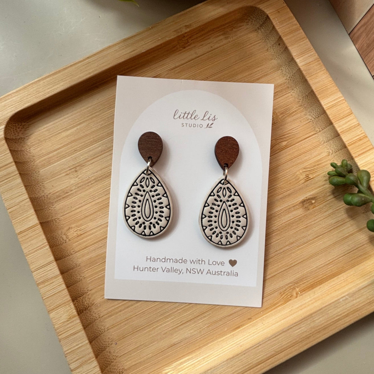A pair of polymer clay teardrop-shaped dangle earrings by 'Little Lis Studio', 