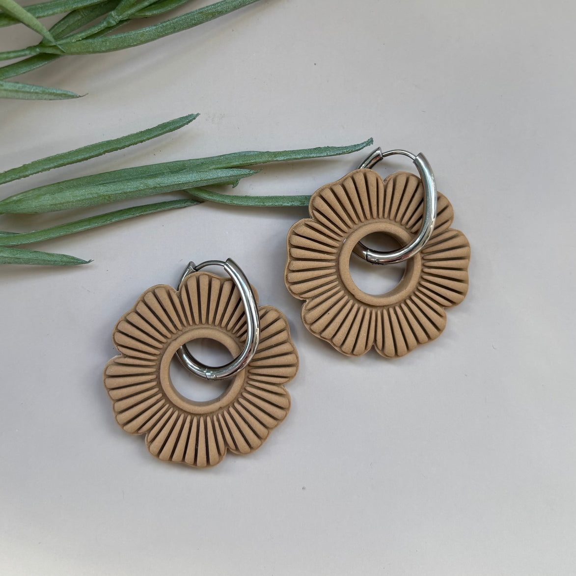 Pair of latte beige circular floral earrings on a 18mm silver hoop