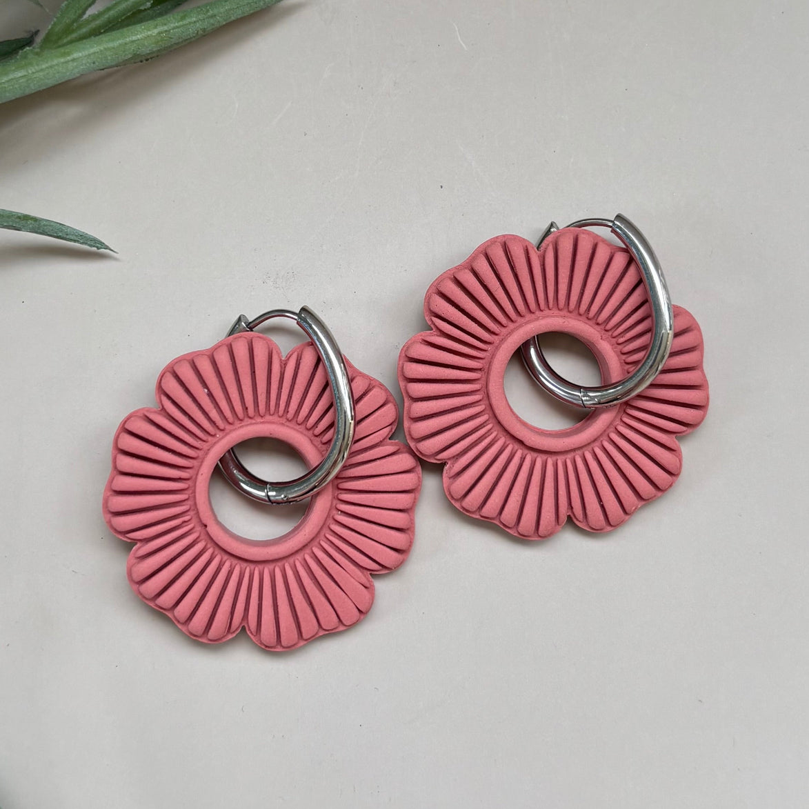 Terracotta orange rust coloured floral shaped donut earring charm on 18mm oval shaped silver hoop